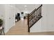 Bright and open foyer with hardwood floors, stairs with wood railing, and view into the living area at 17871 Paula, Westfield, IN 46074