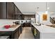 Contemporary kitchen boasts dark cabinetry, quartz countertops, and stainless steel appliances at 17871 Paula, Westfield, IN 46074