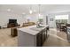 Large kitchen island with stainless steel sink, modern faucet, white countertop, and dark cabinets at 17871 Paula, Westfield, IN 46074