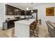Modern kitchen featuring dark wood cabinets, stainless steel appliances, and a white quartz island at 17871 Paula, Westfield, IN 46074