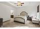 A calming main bedroom features a tray ceiling, ceiling fan, and an adjoining bathroom at 17871 Paula, Westfield, IN 46074
