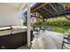 Covered patio with hot tub and rocking chairs overlooking the backyard at 17871 Paula, Westfield, IN 46074