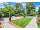 Expansive backyard featuring manicured lawn, gardens, and a pristine pool area at 2505 Riverside Dr, Columbus, IN 47201