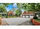 Spacious driveway with brick accents, leading to the garage and a beautifully landscaped garden area at 2505 Riverside Dr, Columbus, IN 47201