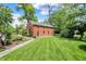 Two-story brick carriage house with lush landscaping at 2505 Riverside Dr, Columbus, IN 47201