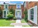 Close-up of the front entrance with a classic white door, decorative pillars, and manicured landscaping at 2505 Riverside Dr, Columbus, IN 47201