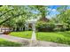 Beautiful brick home featuring a manicured lawn, mature trees, and a stone walkway to the front entrance at 2505 Riverside Dr, Columbus, IN 47201
