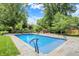 Serene pool and garden area with stone waterfall feature amidst lush greenery and mature trees at 2505 Riverside Dr, Columbus, IN 47201