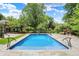 Sparkling pool surrounded by stone patio, lush greenery, and beautiful landscaping offers a serene outdoor experience at 2505 Riverside Dr, Columbus, IN 47201