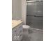 The bathroom features a glass-enclosed shower, toilet, vanity, and gray-tiled floor at 6362 Harmonridge Ct, Indianapolis, IN 46278