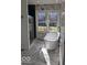 Bright bathroom featuring a standalone tub, marble floors, and a glass-enclosed shower at 6362 Harmonridge Ct, Indianapolis, IN 46278
