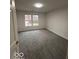 This bedroom features plush gray carpeting and a window with a view of the outdoors at 6362 Harmonridge Ct, Indianapolis, IN 46278