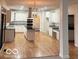 Open kitchen with white cabinets, stainless steel appliances, and a center island at 6362 Harmonridge Ct, Indianapolis, IN 46278