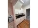 Charming kitchenette with custom white cabinets, granite countertops, and wooden floors at 6362 Harmonridge Ct, Indianapolis, IN 46278