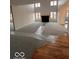 Spacious living room with a fireplace and large windows for natural light at 6362 Harmonridge Ct, Indianapolis, IN 46278