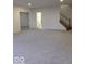 Spacious carpeted living room with a view into the bathroom, and a staircase on the right at 6362 Harmonridge Ct, Indianapolis, IN 46278