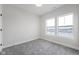 Bright bedroom with grey carpet and two large windows at 804 James William Ln, Westfield, IN 46074