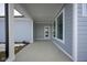 Covered patio with concrete flooring, access door, and gray siding at 804 James William Ln, Westfield, IN 46074