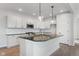 Modern kitchen with white cabinets, granite countertops, and stainless steel appliances at 804 James William Ln, Westfield, IN 46074