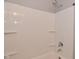 Bathroom featuring a white shower and tub with silver fixtures, plus built in shelving for storage at 1709 Hoyt Ave, Indianapolis, IN 46203