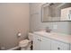 Modern bathroom with a new toilet, vanity, a dark framed mirror, and updated fixtures at 1709 Hoyt Ave, Indianapolis, IN 46203