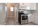 Bright kitchen with stainless steel oven, microwave and white cabinets at 1709 Hoyt Ave, Indianapolis, IN 46203