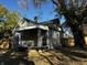 Exterior view of the home with white awnings, porch and green siding at 212 S Good Ave, Indianapolis, IN 46219