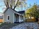 Charming home with light green siding, front porch, and landscaped front yard at 212 S Good Ave, Indianapolis, IN 46219