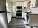 Updated kitchen featuring black appliances, white cabinets, and subway tile backsplash at 212 S Good Ave, Indianapolis, IN 46219