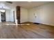 Living room features hardwood floors, white walls and an exposed brick column at 212 S Good Ave, Indianapolis, IN 46219
