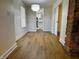 Living room features hardwood floors, white walls and an exposed brick column at 212 S Good Ave, Indianapolis, IN 46219