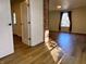 Living room with hardwood floors, brick column, white walls and ample lighting at 212 S Good Ave, Indianapolis, IN 46219