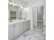 Elegant bathroom featuring double vanity, marble floors, and tiled walk-in shower and recessed lighting at 2639 Collins Dr, Westfield, IN 46074