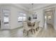 Dining area features modern lighting and neutral colors, and a view to the home's outdoor area at 2639 Collins Dr, Westfield, IN 46074