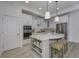 Kitchen with white cabinets and stainless steel appliances, features an eat-in island at 2639 Collins Dr, Westfield, IN 46074