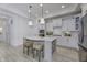 Kitchen with white cabinets and stainless steel appliances, features an eat-in island at 2639 Collins Dr, Westfield, IN 46074