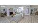 This bright, neutral living room features a fireplace, hardwood floors, and a door to the home's outdoor space at 2639 Collins Dr, Westfield, IN 46074