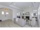 Bright living room features a fireplace, light wood floors, neutral decor, and a view to the home's entrance at 2639 Collins Dr, Westfield, IN 46074