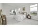 Bright main bedroom features neutral décor, plush carpet, sitting room, and ample natural light from large windows at 2639 Collins Dr, Westfield, IN 46074