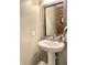 Stylish half-bathroom featuring modern sink and tiled mirror at 5778 W Commonview Dr, McCordsville, IN 46055