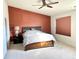 This is a bedroom with a large bed, ceiling fan and an accent wall in a contrasting color at 5778 W Commonview Dr, McCordsville, IN 46055