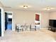 Carpeted bonus room features twin chairs, a glass table, and open doorways that provide access to other rooms at 5778 W Commonview Dr, McCordsville, IN 46055