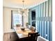 An inviting dining room with a unique light fixture and contemporary decor at 5778 W Commonview Dr, McCordsville, IN 46055