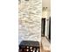 The entryway features a stacked stone accent wall, shoe storage bench, and a rug that lines the hardwood floor at 5778 W Commonview Dr, McCordsville, IN 46055