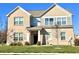 Charming two-story home featuring a well-maintained lawn and a classic brick facade at 5778 W Commonview Dr, McCordsville, IN 46055