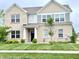 Charming two-story brick home featuring a well-manicured lawn and a welcoming entrance at 5778 W Commonview Dr, McCordsville, IN 46055
