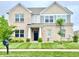 Charming two-story brick home featuring a well-manicured lawn and a welcoming entrance at 5778 W Commonview Dr, McCordsville, IN 46055