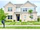 Charming two-story brick home featuring a well-manicured lawn and a welcoming entrance at 5778 W Commonview Dr, McCordsville, IN 46055