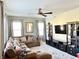 Spacious living room with comfortable seating, lots of natural light and mounted TV at 5778 W Commonview Dr, McCordsville, IN 46055