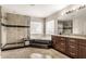 Bathroom featuring a walk-in shower, soaking tub, and vanity with dark wood cabinetry and granite countertops at 12583 Robinbrook Dr, Carmel, IN 46033